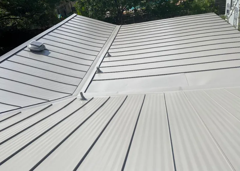 Solar attic fan installed on a metal roof for Roof Ventilation in Ann Arbor